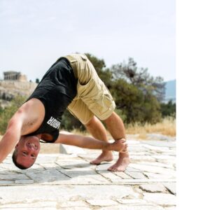 Yogi Aaron in downdog smiling