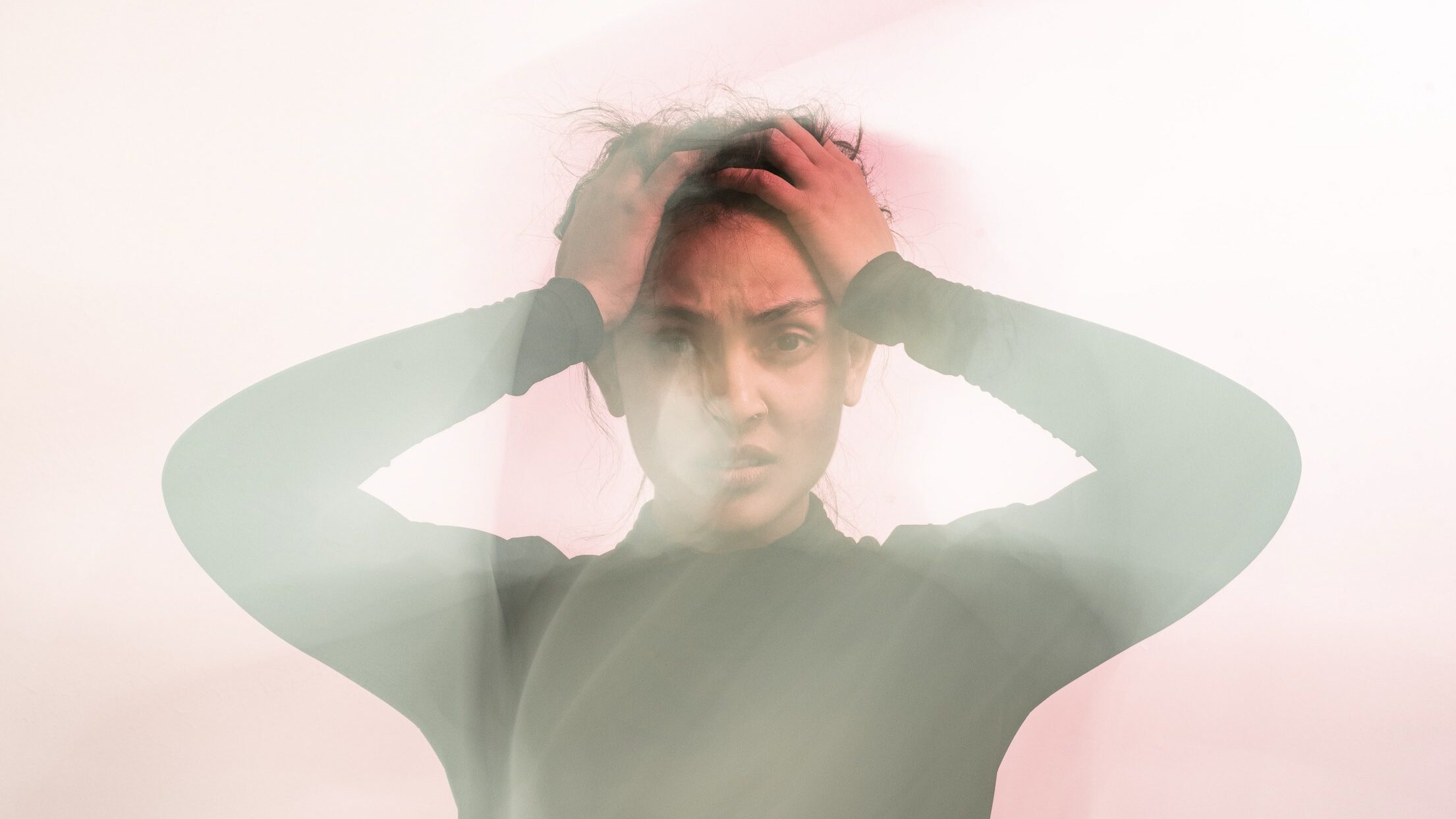 Woman holding her head in agitation.