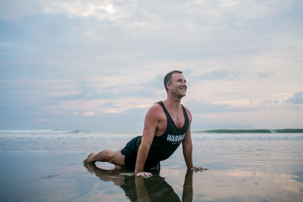 Man practice Yoga on the beach 