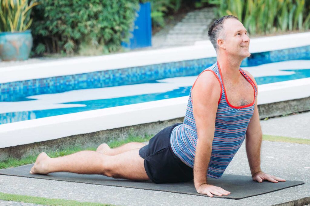 Yogi Aaron doing Updog Yoga Pose at Blue Osa Yoga Retreat's Pool 