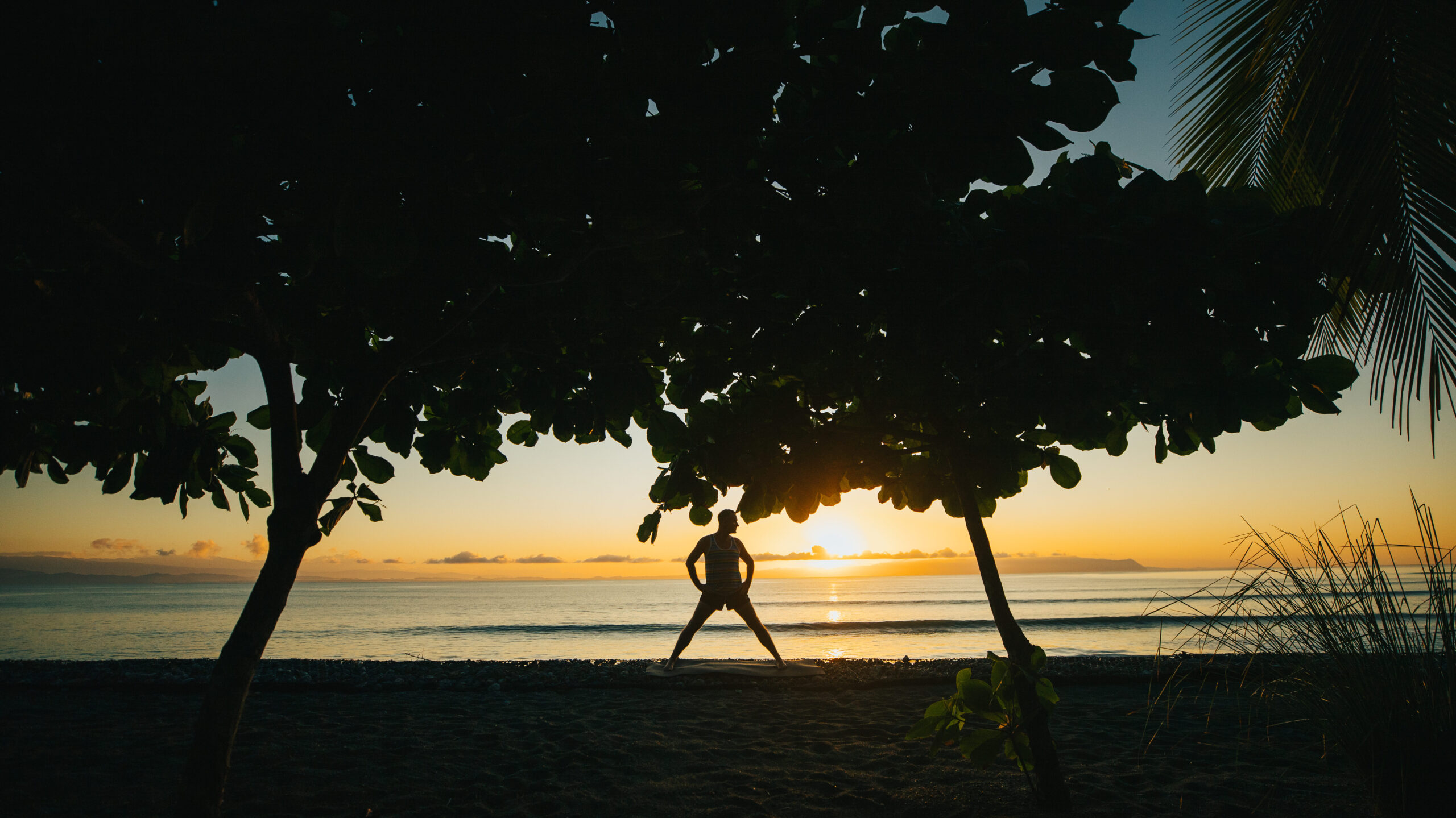Yogi Aaron silhouetted at Sunrise at Blue Osa Yoga Retreat 