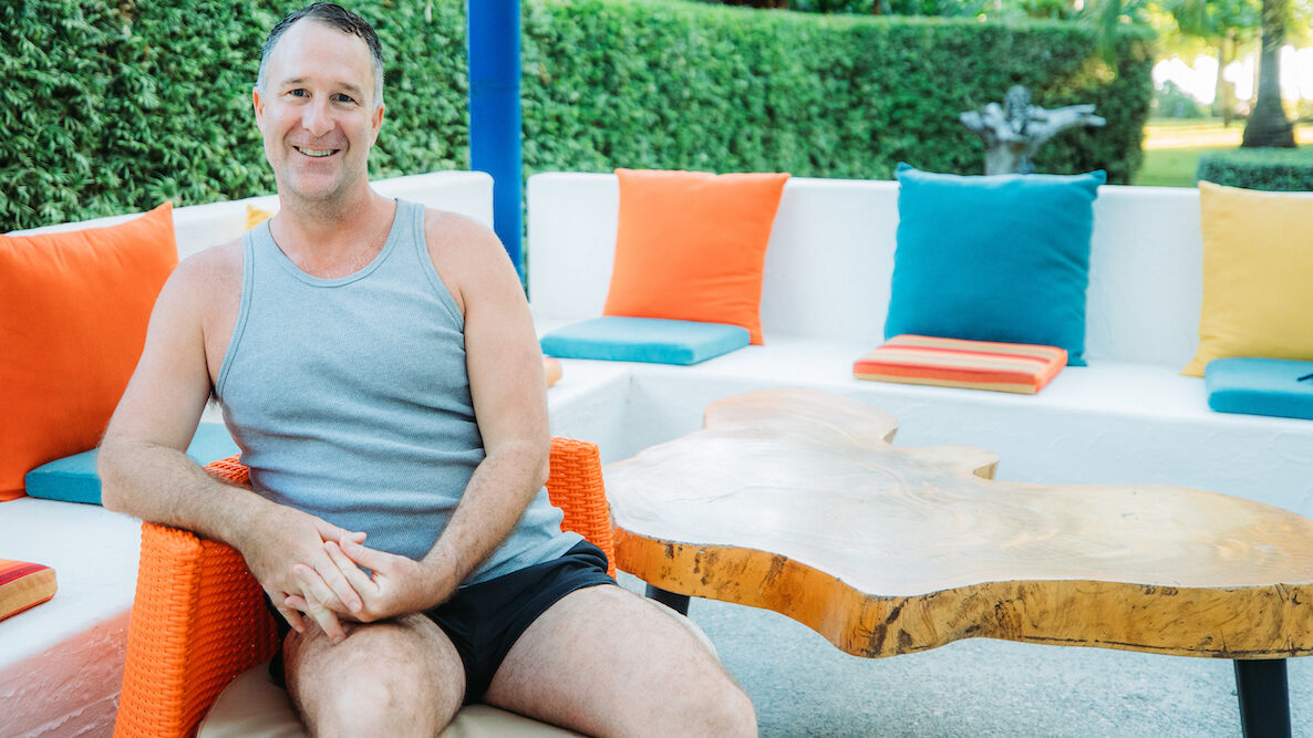 Yogi Aaron Sitting at Blue Osa Yoga Retreat Pool Deck