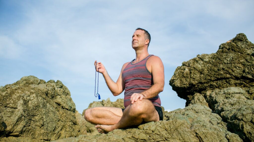 Yogi Aaron Meditating holding Mala beads