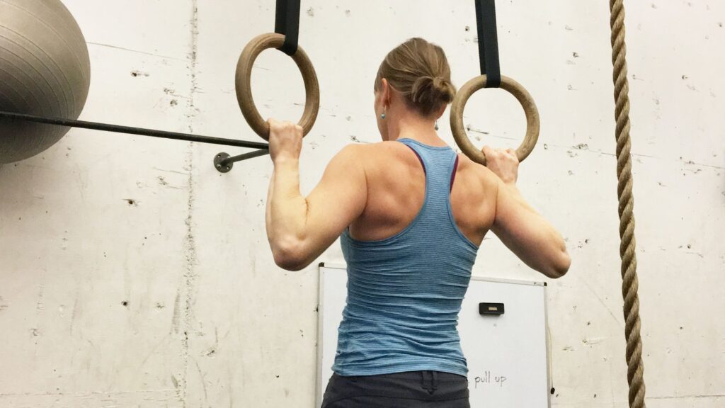 Women on gymnastics rings with strong shoulders