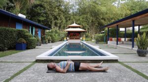 a person lying in savasana corpse pose