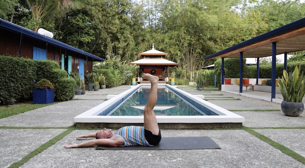 man lying on back with legs at 90 degrees | Supta dundasana