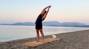 yoga for energy with yogi aaron greece beach standing side bend pose