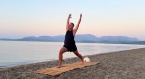 yoga for energy with yogi aaron greece beach 5 high lunge pose