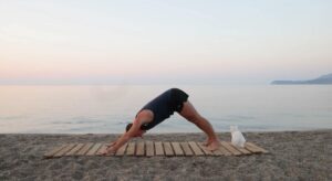 yoga for energy with yogi aaron greece beach 6 downward facing dog