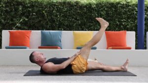 Yoga to stay young with Yogi Aaron leg raise with chest lift pose