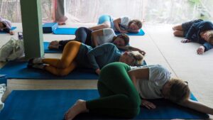Yoga Class with Students doing a restorative side lying pose