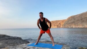Yogi Aaron demonstrating a forward fold with core activation