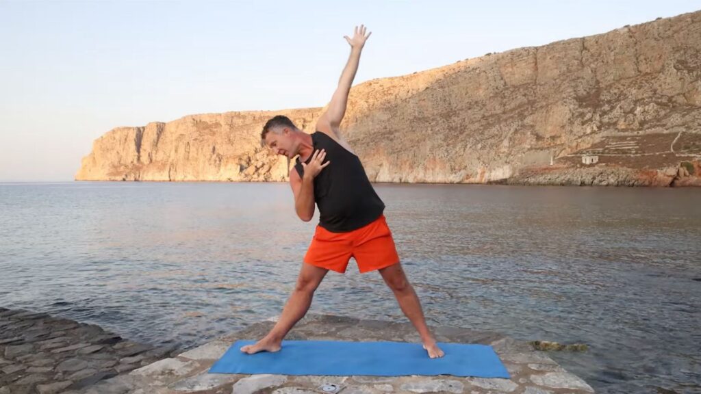 Yogi Aaron demonstrating a side bending triangle yoga pose