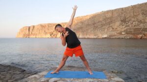 Yogi Aaron demonstrating a side bending triangle yoga pose