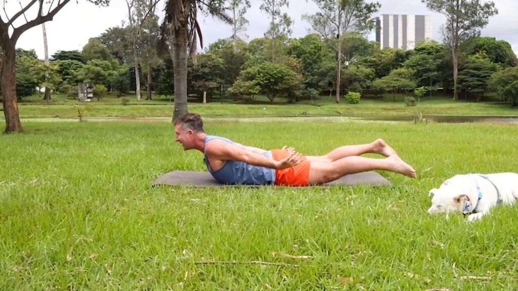 Yogi Aaron, creator of the AYAMA Method, demonstrating Locust Pose for Parkinson's Disease