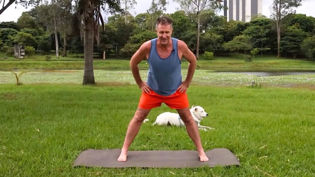 Yogi Aaron demonstrating a modified forward fold for Parkinson's Disease using the AYAMA Method