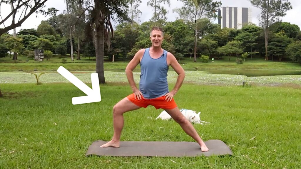 Yogi Aaron, creator of the AYAMA Method, demonstrating Warrior 2 pose for Parkinson's disease