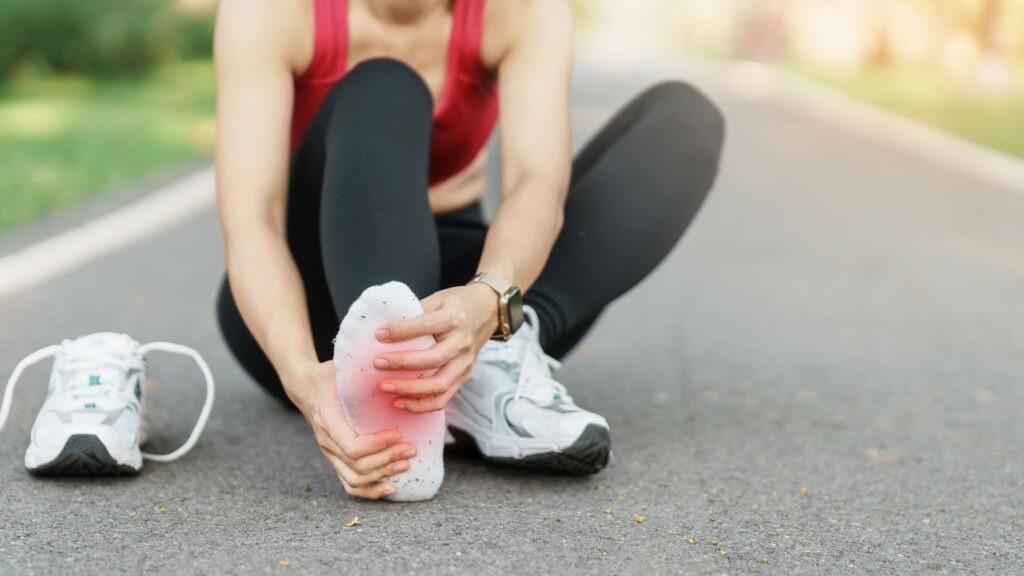 Women holding her foot due to pain from Planta Fascitis