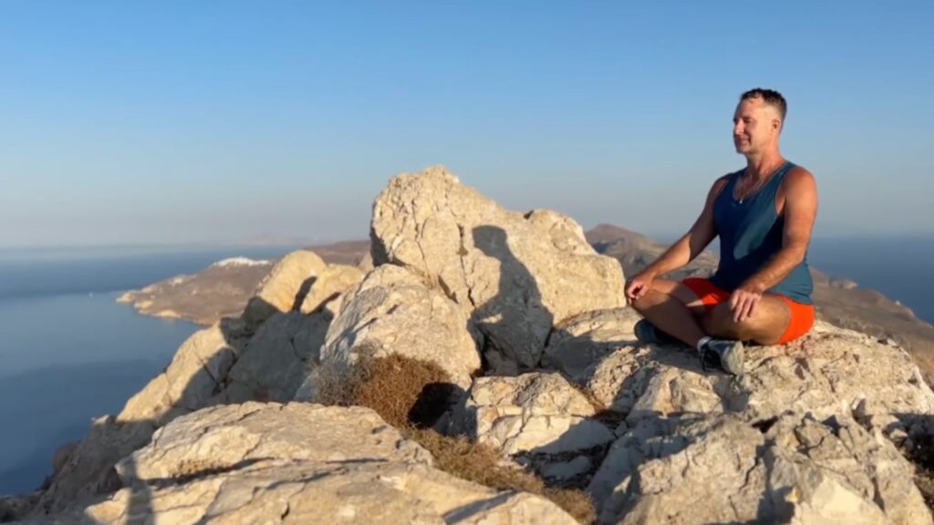 Yogi Aaron meditating on a mountain top