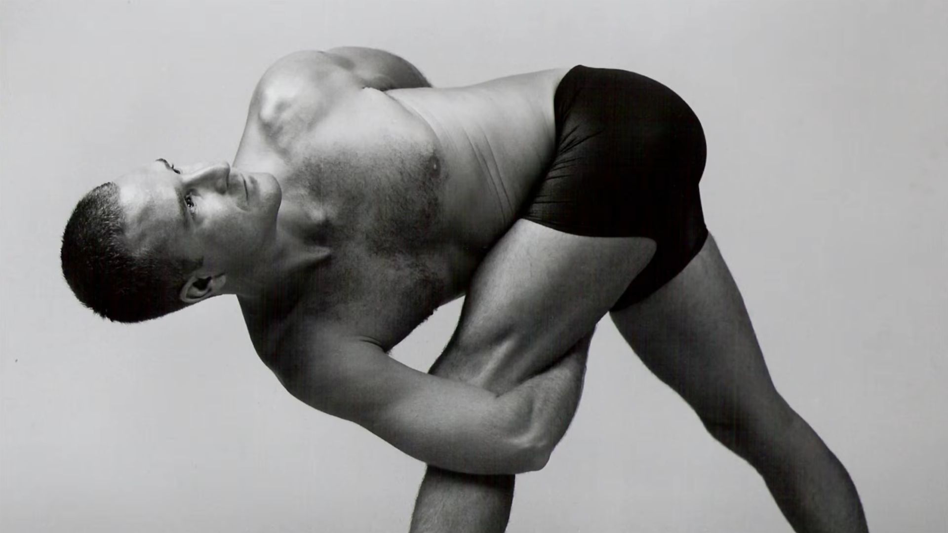 Yogi Aaron practicing Twisting Triangle Pose in Black & White Photography