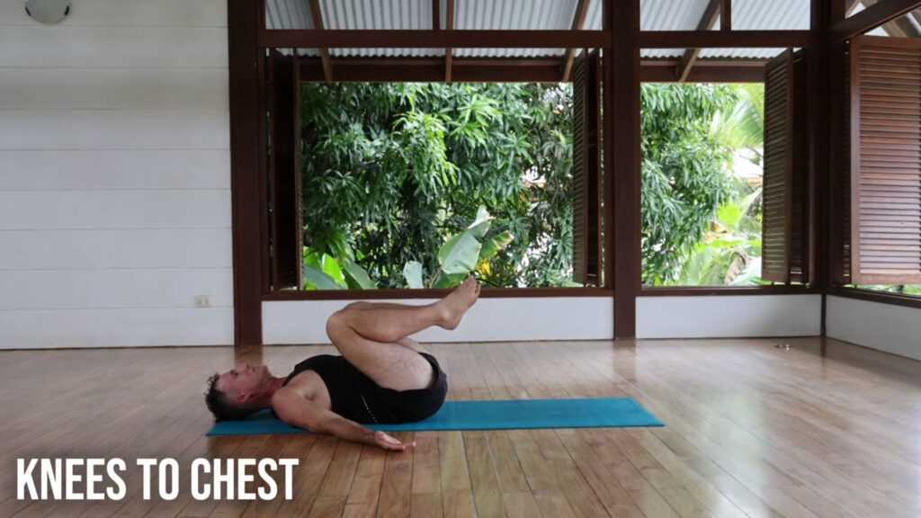 Yogi Aaron doing Knees to Chest Pose