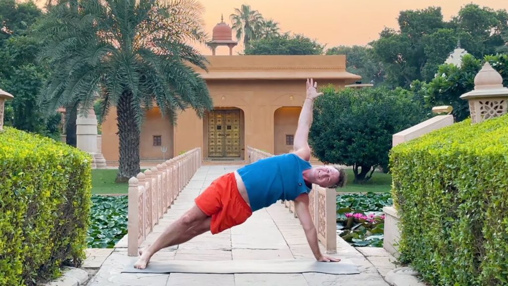 Yogi Aaron practicing yoga in front of the Shiva Temple in India