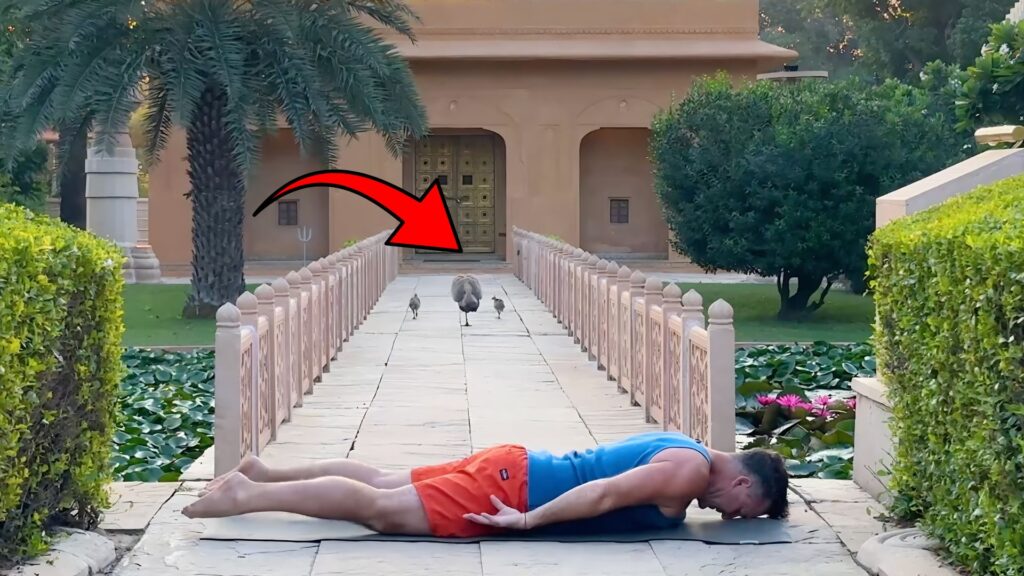 Yogi Aaron practicing Savasana in front of the Shiva Temple with Peacocks in the background